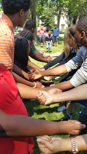 Students from Bethune Middle school join hands with Scholars from Marygrove.