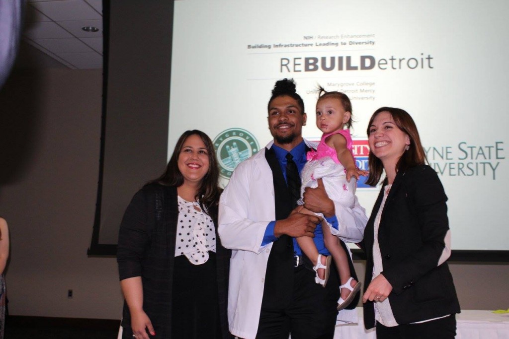 ReBUILDetroit scholar Anthony Croft (center) with his daughter.